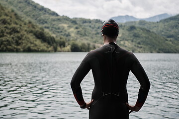 Image showing triathlete swimmer portrait wearing wetsuit on training