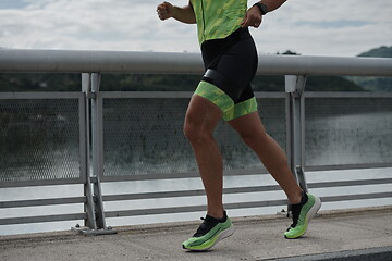 Image showing triathlon athlete running on street