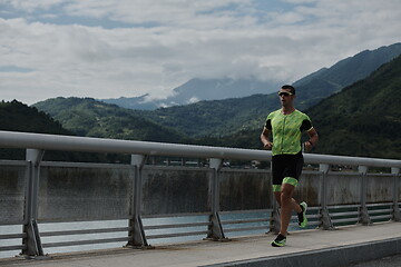 Image showing triathlon athlete running on street