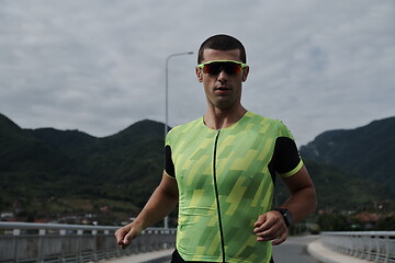 Image showing triathlon athlete running on street