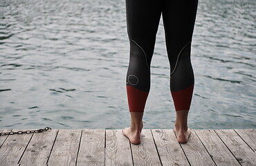 Image showing triathlete swimmer portrait wearing wetsuit on training