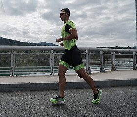 Image showing triathlon athlete running on street