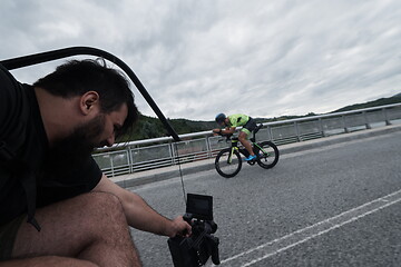 Image showing videographer taking action shot of triathlon bike athlete