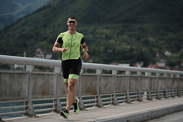 Image showing triathlon athlete running on street