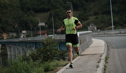 Image showing triathlon athlete running on street