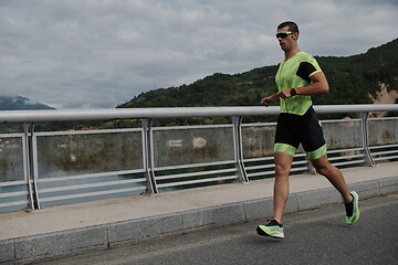 Image showing triathlon athlete running on street