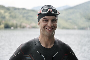 Image showing triathlete swimmer portrait wearing wetsuit on training