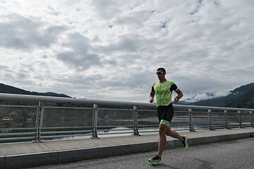 Image showing triathlon athlete running on street