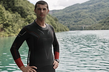 Image showing triathlete swimmer portrait wearing wetsuit on training