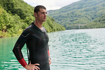 Image showing triathlete swimmer portrait wearing wetsuit on training