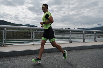 Image showing triathlon athlete running on street