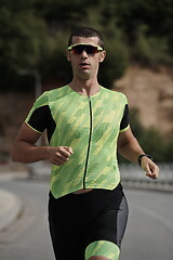 Image showing triathlon athlete running on street