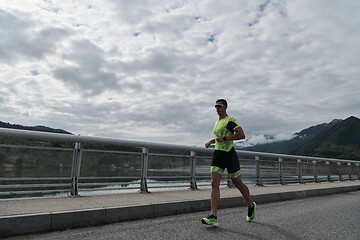 Image showing triathlon athlete running on street