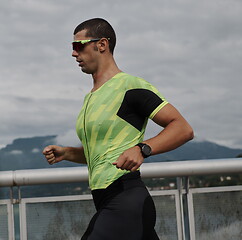 Image showing triathlon athlete running on street