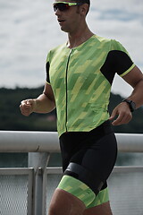 Image showing triathlon athlete running on street