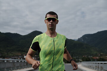 Image showing triathlon athlete running on street