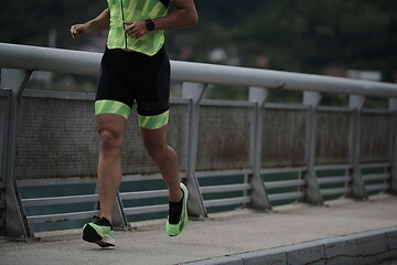 Image showing triathlon athlete running on street