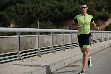 Image showing triathlon athlete running on street