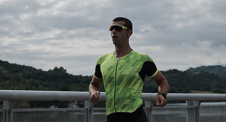 Image showing triathlon athlete running on street