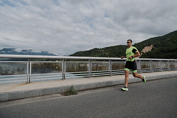 Image showing triathlon athlete running on street