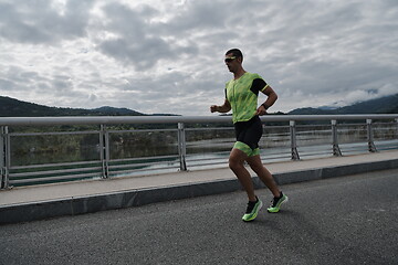 Image showing triathlon athlete running on street