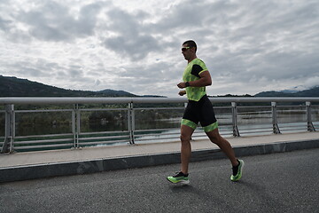 Image showing triathlon athlete running on street