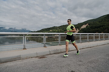 Image showing triathlon athlete running on street