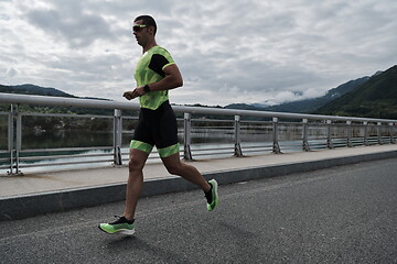 Image showing triathlon athlete running on street