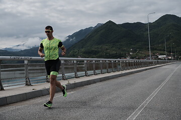 Image showing triathlon athlete running on street