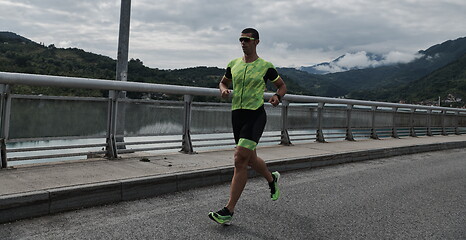 Image showing triathlon athlete running on street