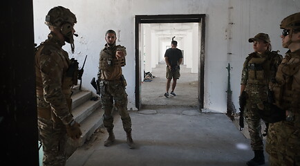 Image showing Videographer Taking Action Shoot of Soldiers in Action urban environment