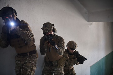 Image showing modern warfare soldiers ascent stairs in combat