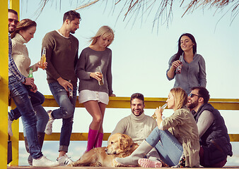 Image showing Group of friends having fun on autumn day at beach