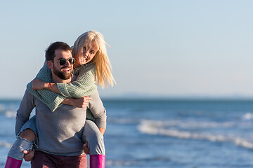 Image showing couple having fun at beach during autumn