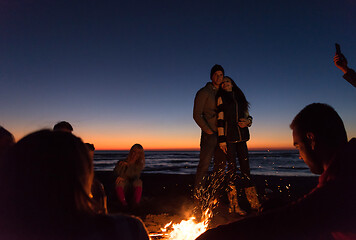 Image showing Friends having fun at beach on autumn day