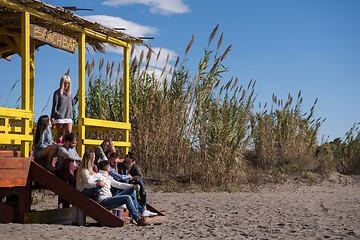 Image showing Group of friends having fun on autumn day at beach