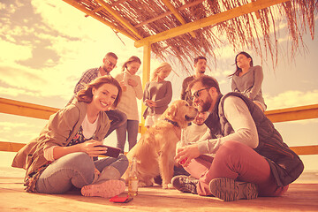 Image showing Group of friends having fun on autumn day at beach