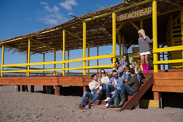 Image showing Group of friends having fun on autumn day at beach