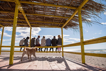 Image showing Group of friends having fun on autumn day at beach