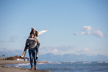 Image showing couple having fun at beach during autumn