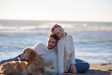 Image showing Couple with dog enjoying time on beach