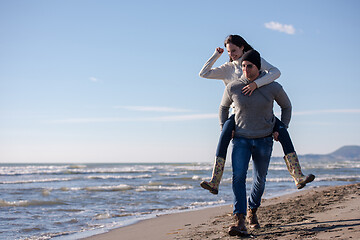 Image showing couple having fun at beach during autumn