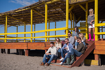 Image showing Group of friends having fun on autumn day at beach