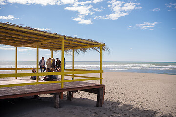 Image showing Group of friends having fun on autumn day at beach