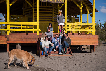 Image showing Group of friends having fun on autumn day at beach