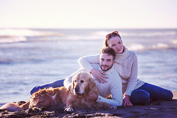 Image showing Couple with dog enjoying time on beach