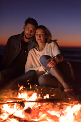 Image showing portrait of young Couple enjoying  at night on the beach