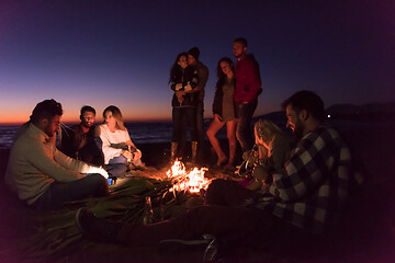 Image showing Friends having fun at beach on autumn day