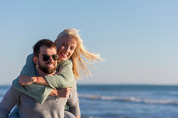 Image showing couple having fun at beach during autumn