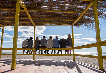 Image showing Group of friends having fun on autumn day at beach